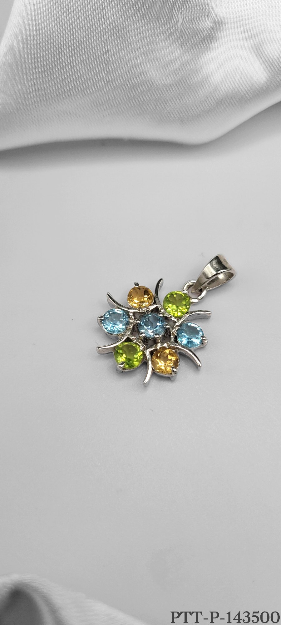 STRIKING COMBINATION OF PERIDOT, YELLOW TOPAZ & BLUE TOPAZ PENDANT ON STERLING SILVER. PERIDOT KNOWN AS THE STONE OF CAMPASSION. TOPAZ SYMBOLIZES LOVE & AFFECTION, MERGED INTO A UNIQUE PIECE